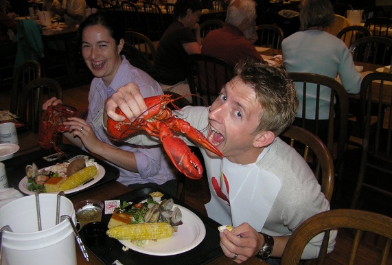 Course participant holding a Maine lobster at dinner, c. 2008