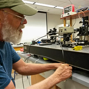 Instructor fine-tuning a flow cytometer optical bench